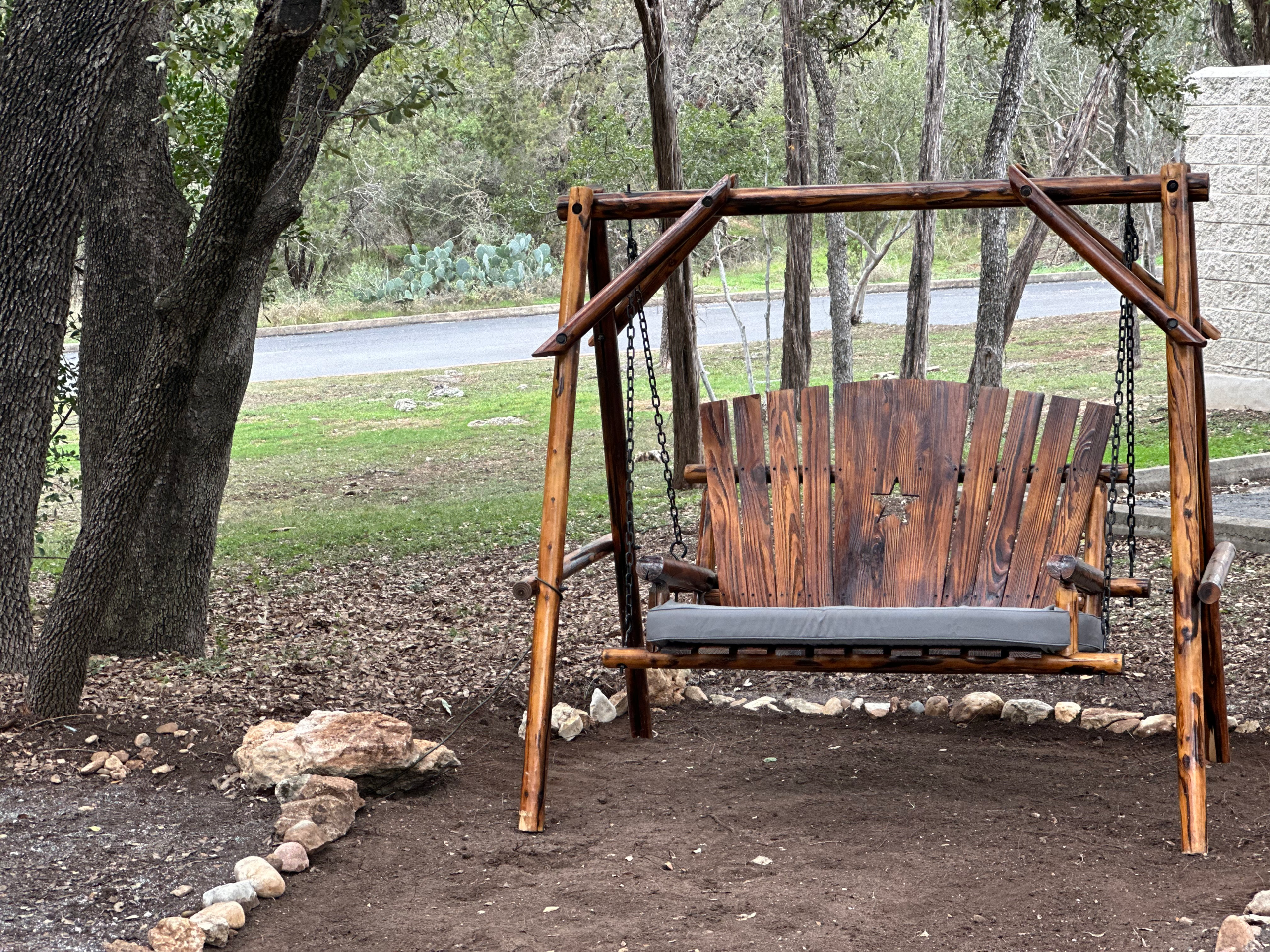 Outdoor Reflection Space at Austin Ketamine Clinic Outdoor reflection space with wooden swing at Austin Ketamine Clinic in Austin Texas providing a peaceful environment for mental health healing and personal reflection.